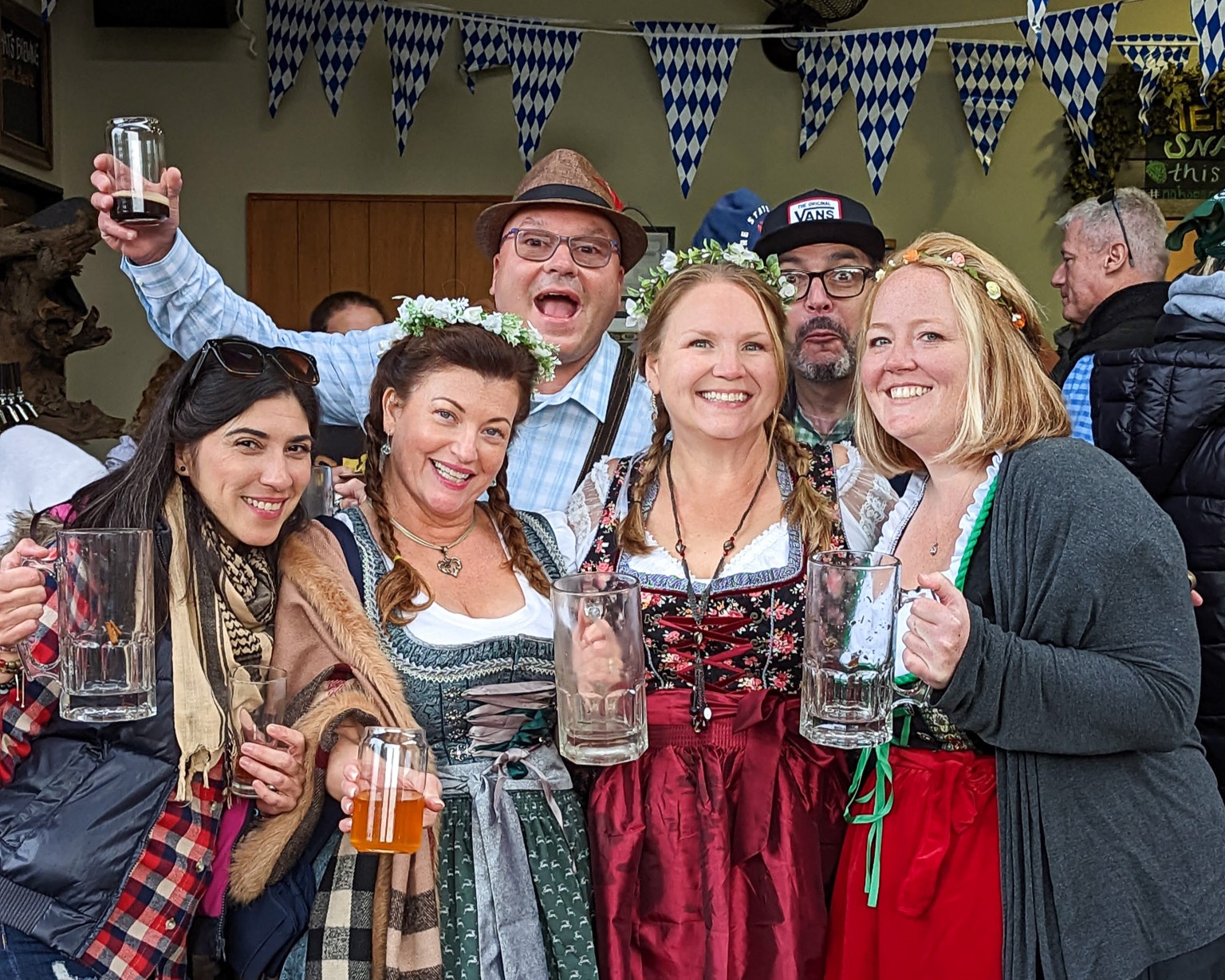 women and men celebrate in German Oktoberfest attire