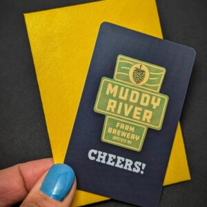 woman with blue fingernails holds a gift card featuring a logo and the word "cheers"